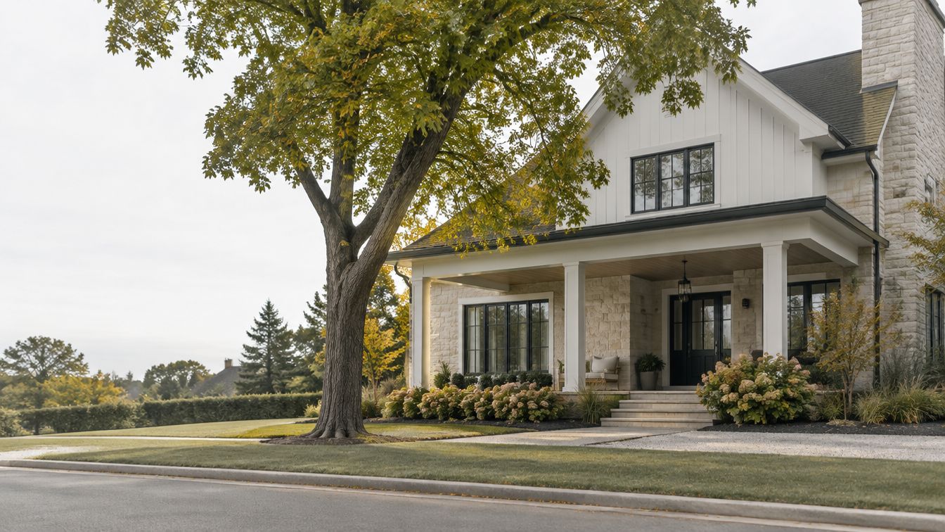 Concept art of a custom home with stonework, a deep porch and mature landscaping